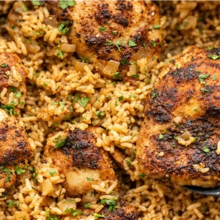 One-Pot Chicken & Rice Dinner - chicken rice - Chicken rice: make this easy one-pot dish in under an hour. Juicy, seasoned chicken thighs and fluffy rice, cooke